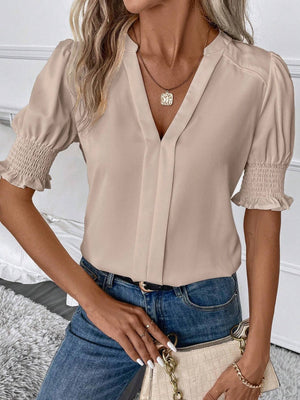 Tan shirred sleeve blouse with plunge neckline and v-neck detail