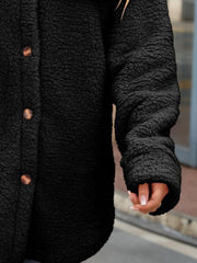 Black teddy-texture button-down shacket with wooden buttons and cuffed sleeves.