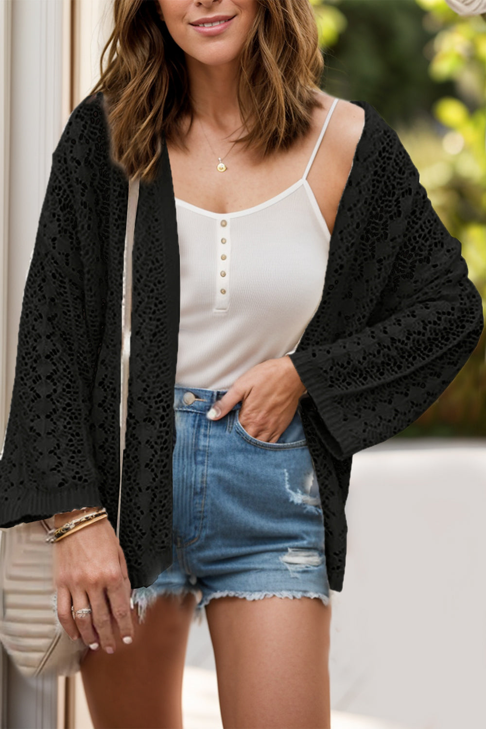 Black open-knit crochet cardigan with wide sleeves and a relaxed fit.