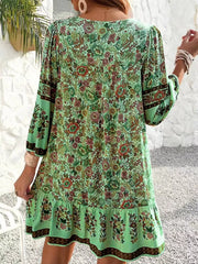 Matcha green floral print mini dress with tiered ruffle hem and tassel tie detail.