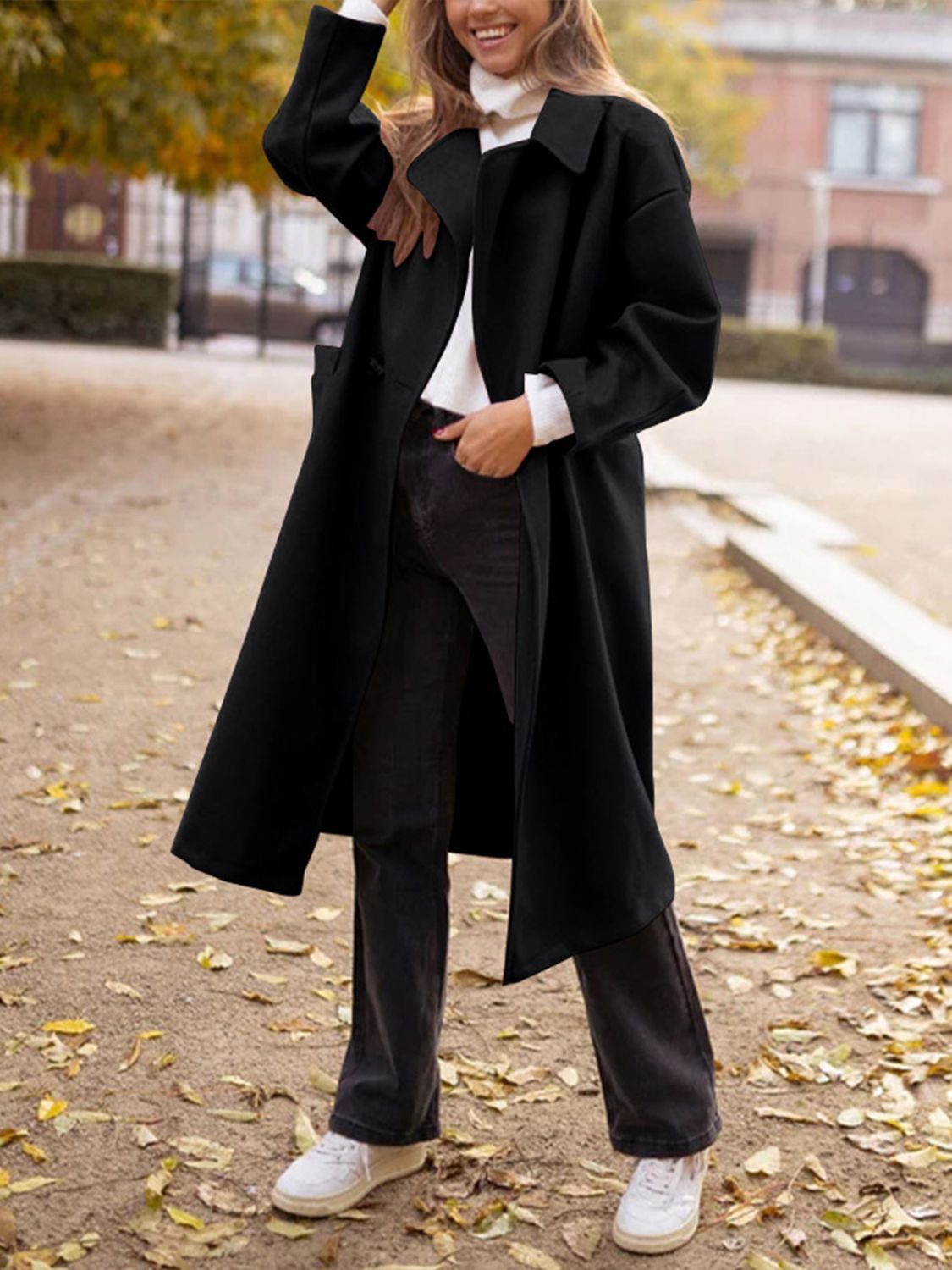 Black oversized wool-blend cocoon coat with wide lapels and a relaxed fit.