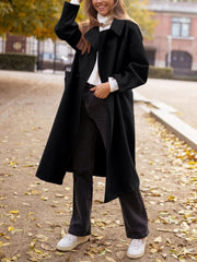 Black oversized wool-blend cocoon coat with wide lapels and a relaxed fit.