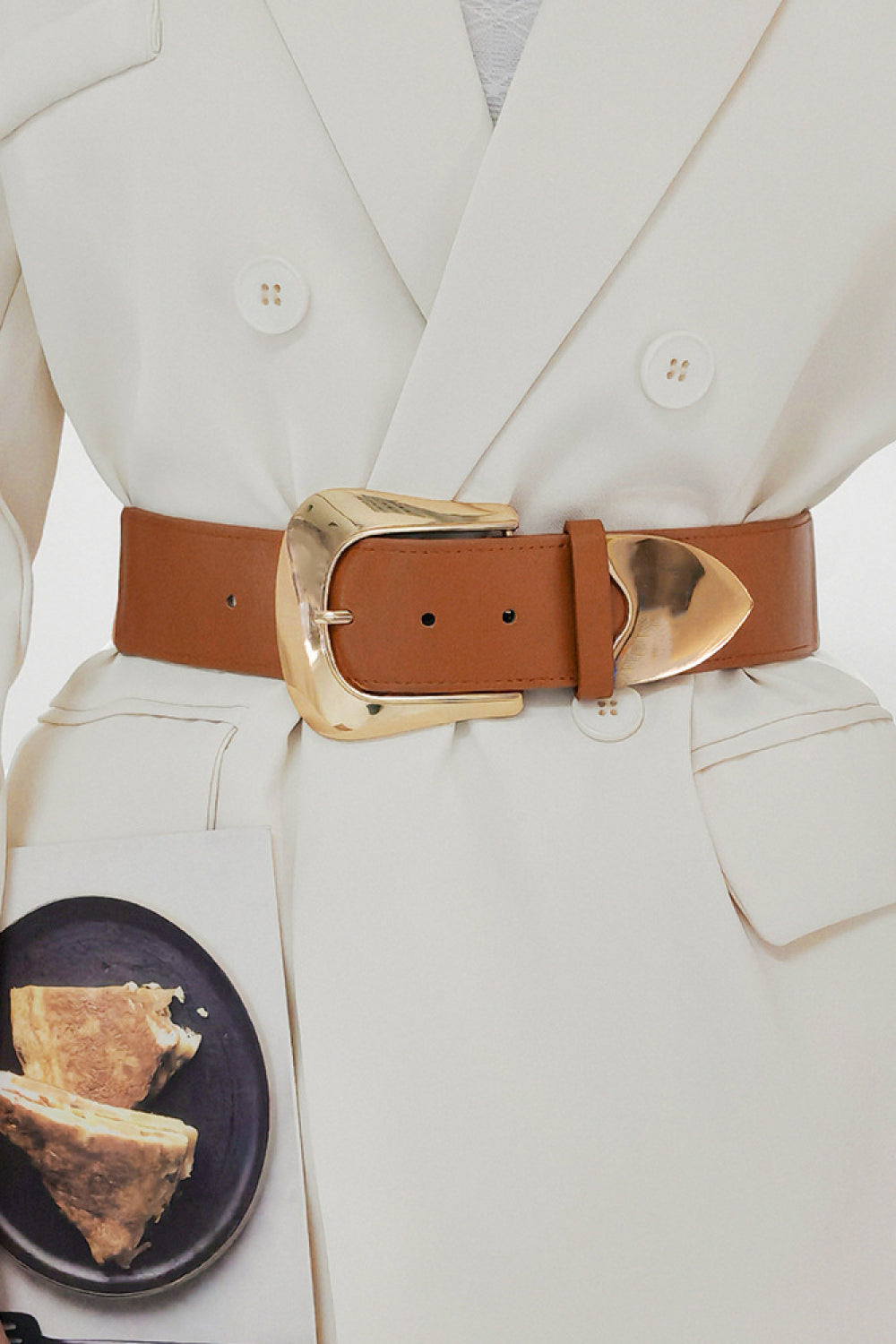 Caramel leather belt with sculpted gold buckle, adjustable.