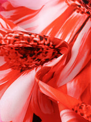 Toddler dress with a vibrant red and white floral print, featuring a close-up of the fabric texture.