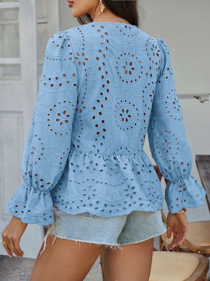 Light blue eyelet embroidered peplum blouse with ruffled cuffs and balloon sleeves.