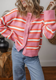 Pink striped knit cardigan with button front and crew neck.