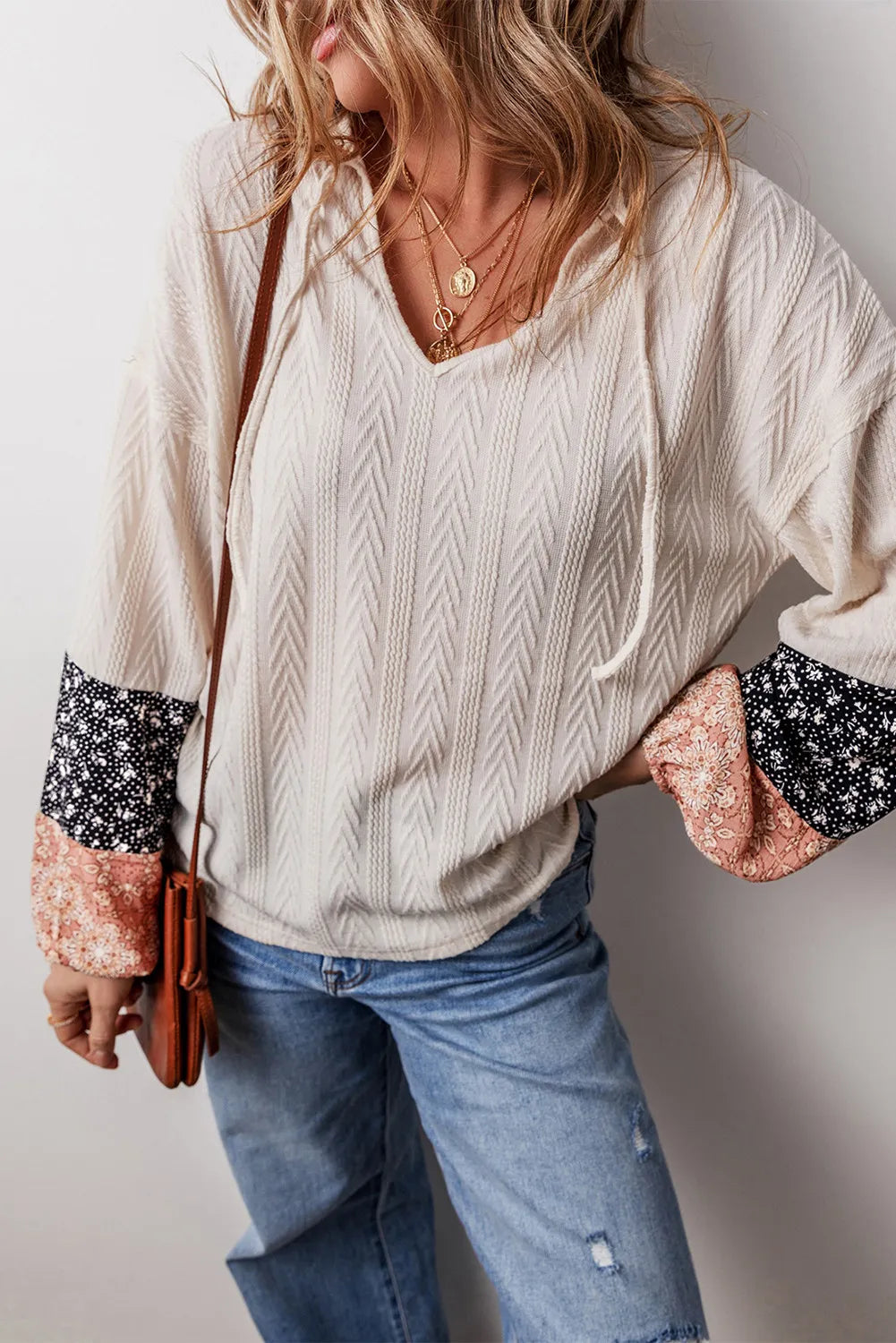 Textured sleeve henley blouse in cream with patchwork floral print sleeves.