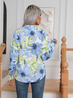 Light blue floral print blouson sleeve button-up shirt with smocked cuffs.