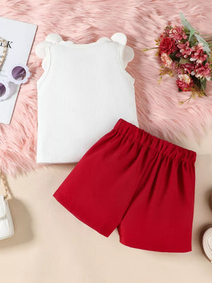 Baby girl's white ribbed tank top with ruffled sleeves and red bow skort.