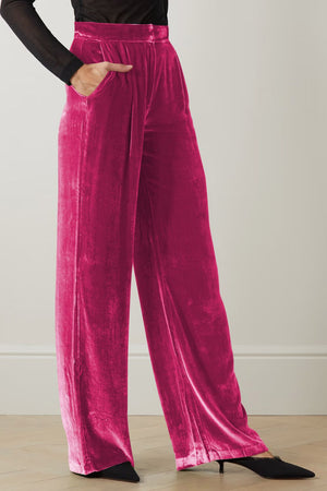 Hot pink velvet palazzo trousers with high waist and side pockets.