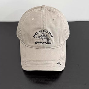 Khaki cotton cap with floral embroidery and text detail