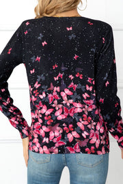 Black crewneck cardigan with allover pink butterfly print and white speckles