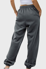Relaxed-fit cuffed sweatpants in dark gray with an elastic waistband and pockets.