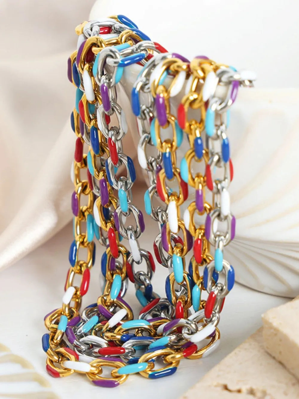 Enamel link bracelet with gold accents and colorful enamel in red, blue, purple, white, and turquoise.