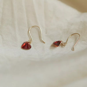 Dainty red heart-shaped zircon drop earrings with gold hooks.