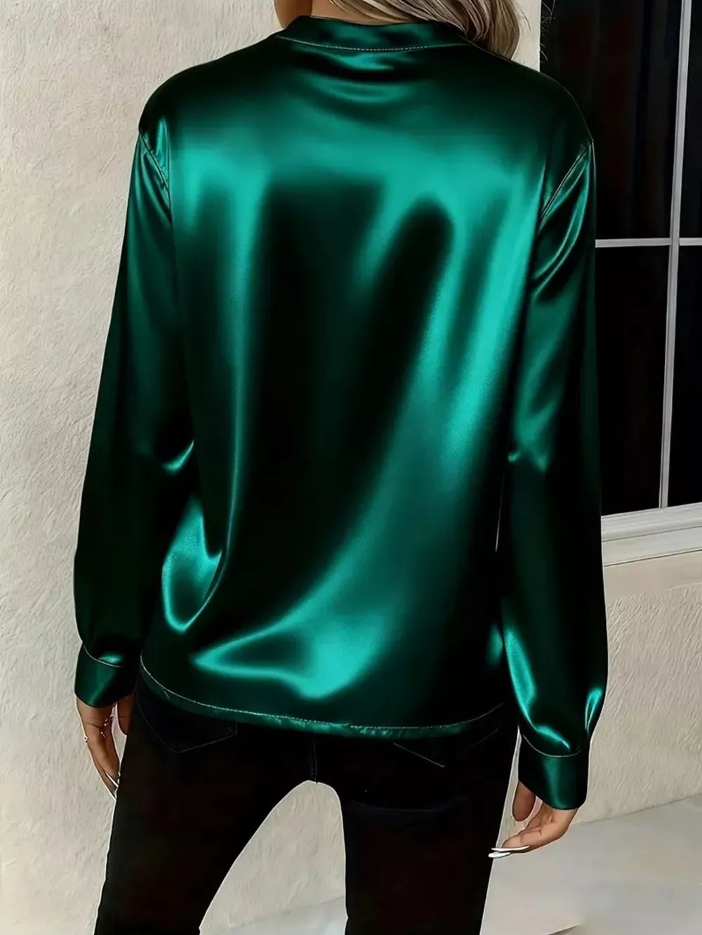 Green satin maternity blouse with buttoned cuffs and a notched V-neck.