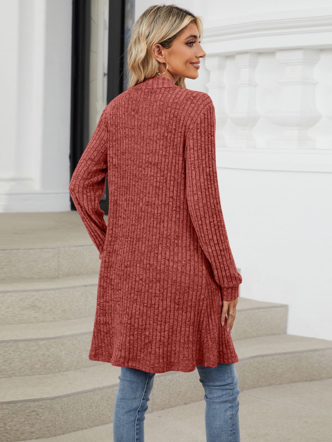 Textured ribbed knit duster cardigan in rust with long sleeves and a cascading open front.