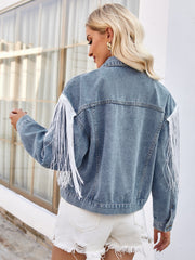 Medium wash denim trucker jacket with white fringe trim on sleeves and shoulders.