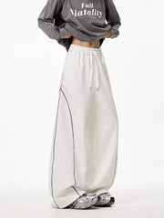 Light gray wide-leg drawstring sweatpants with contrast stitching detail.