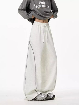 Light gray wide-leg drawstring sweatpants with contrast stitching detail.