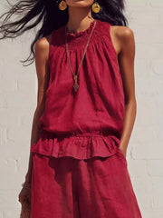 Scarlet smocked peplum top and flowing pants set with ruffled hem.