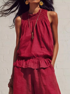 Scarlet smocked peplum top and flowing pants set with ruffled hem.