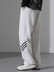 Light Flower Gray sweatpants with black stripes detail and loose fit.