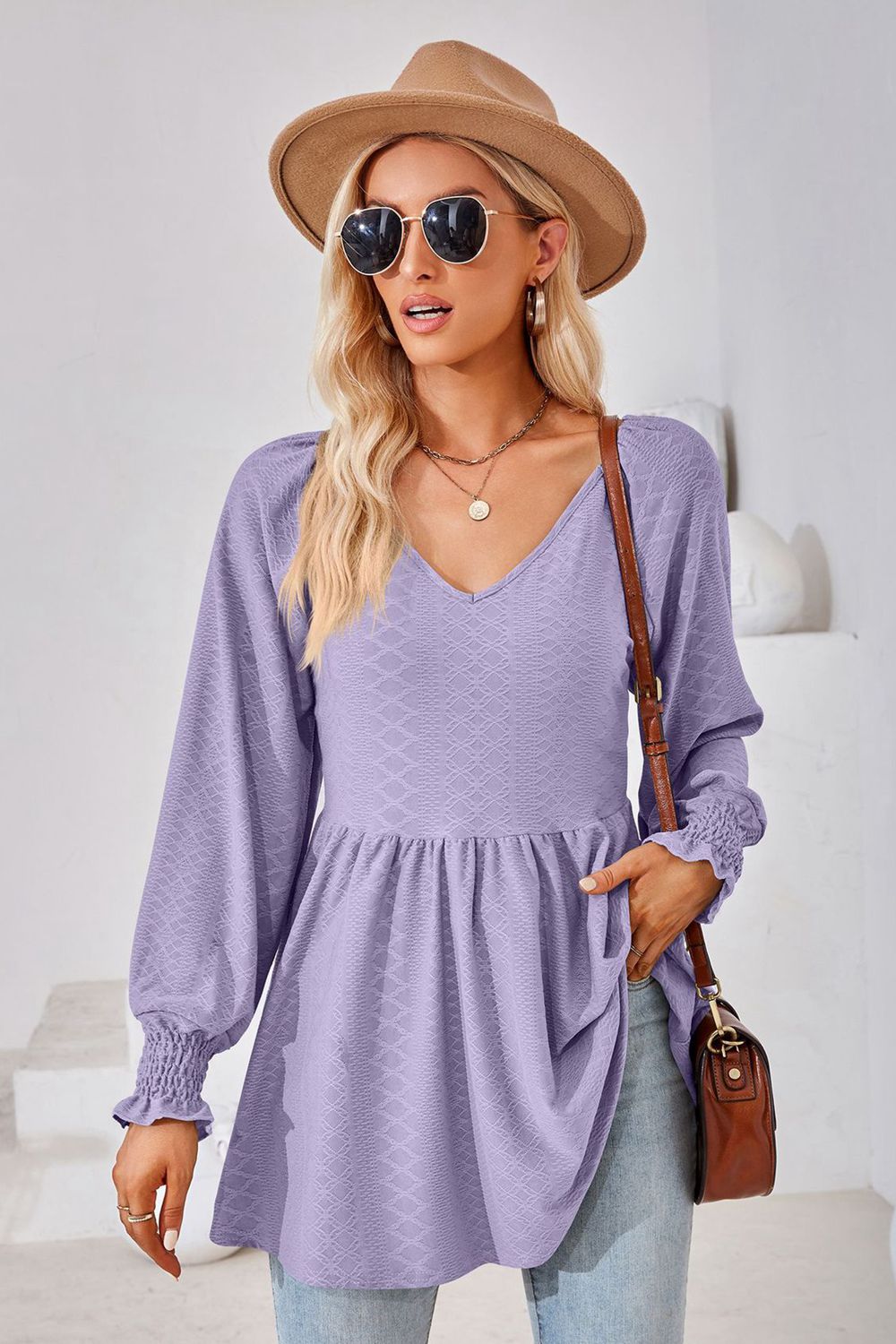 Lavender textured babydoll blouse with v-neck and smocked cuffs