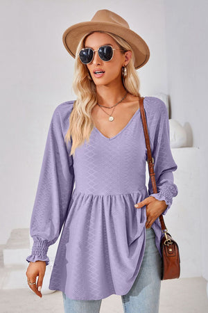 Lavender textured babydoll blouse with v-neck and smocked cuffs