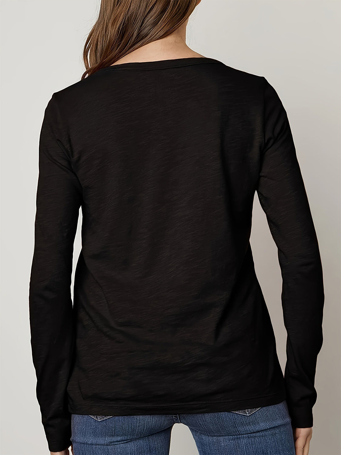Black long sleeve casual top with a textured finish.