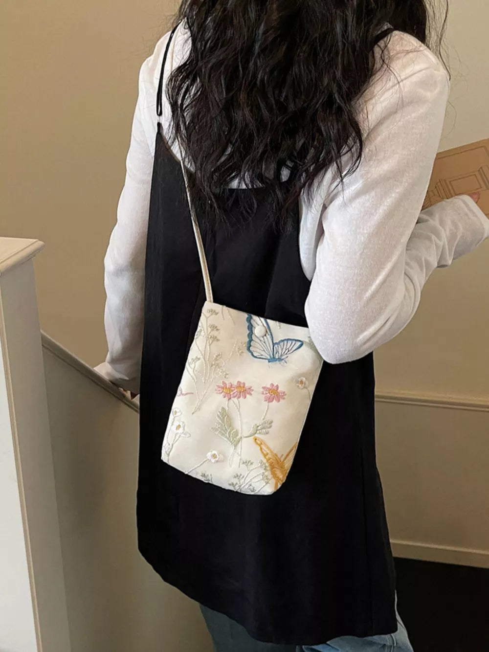 Off-white crossbody bag with delicate floral and butterfly embroidery