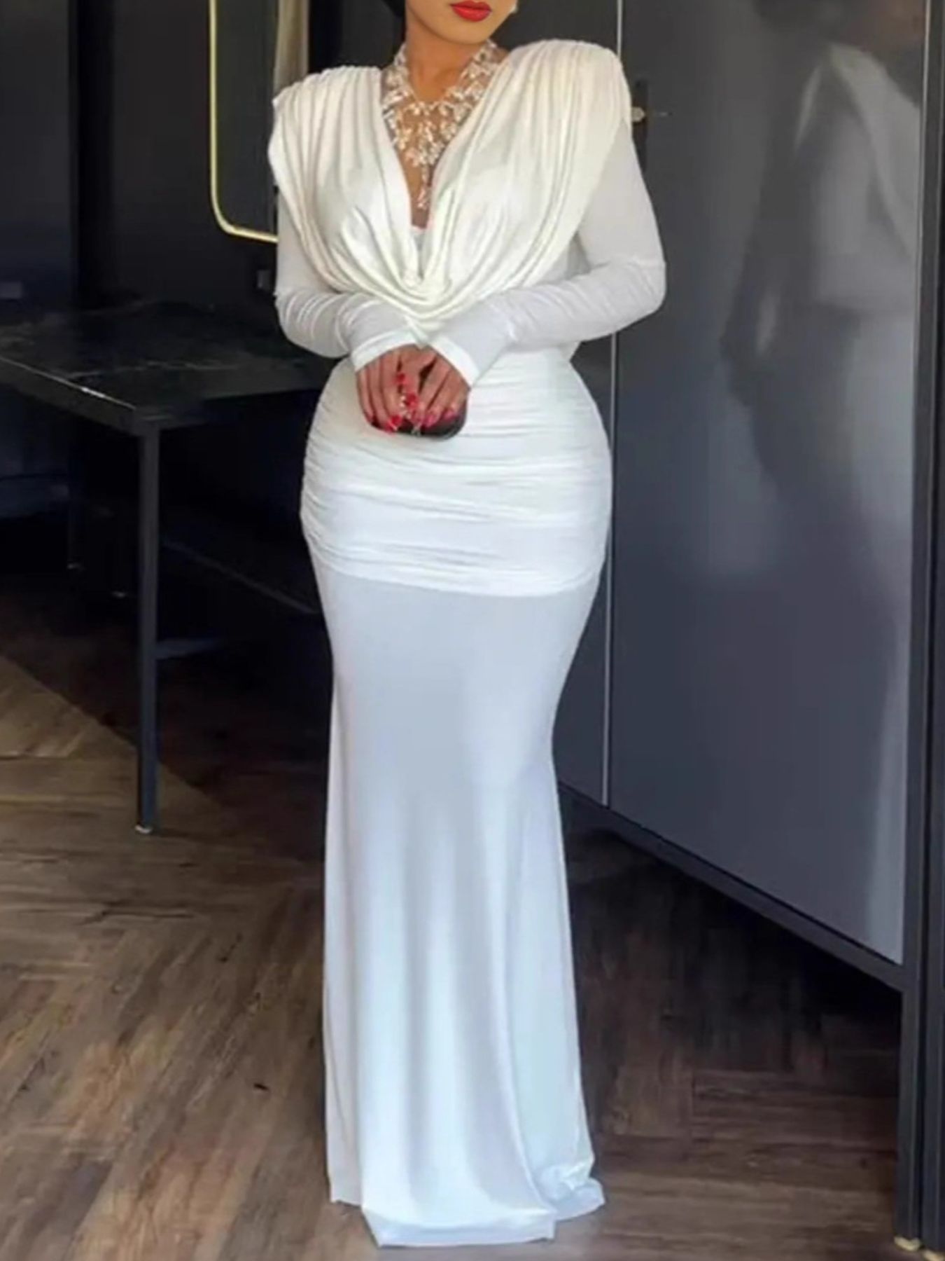 White ruched long-sleeve maxi dress with cowl neck and draped bodice.