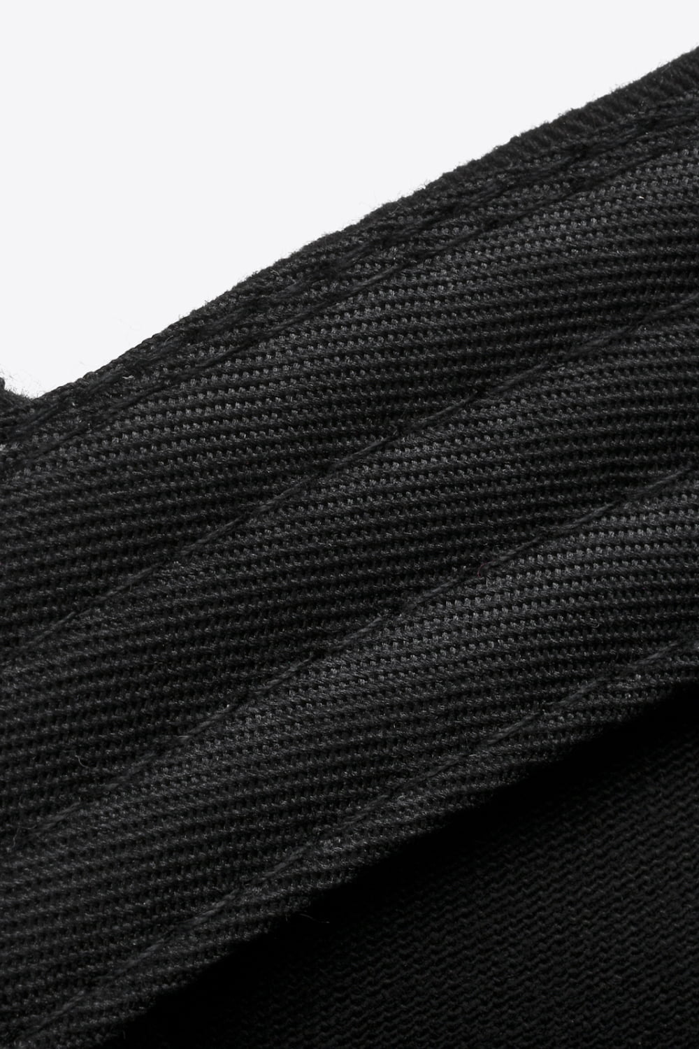 Black baseball cap with textured fabric and stitched details