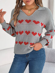 Gray knit polo sweater with red heart pattern and v-neck.