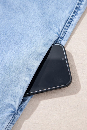 Light blue denim sundress with pocket detail and a smartphone.