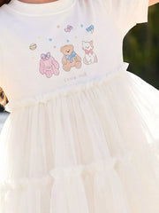 White cotton dress with cartoon bear, bunny, cat print and tiered tulle skirt.