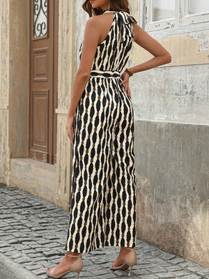 Geometric halter neck jumpsuit with tie in cream and black pattern, wide leg.