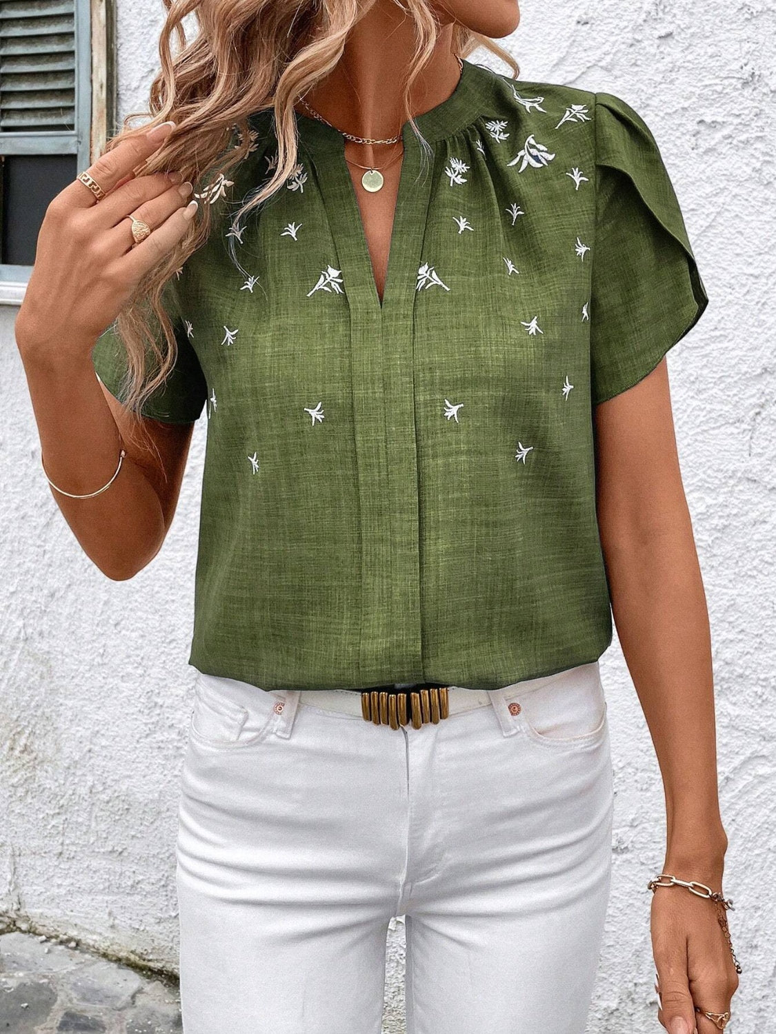 Matcha green embroidered floral keyhole blouse with short sleeves and a v-neckline.