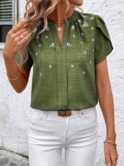 Matcha green embroidered floral keyhole blouse with short sleeves and a v-neckline.
