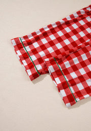 Festive red and white gingham pajama set with green trim detail.