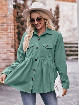 Turquoise corduroy peplum shirt jacket with buttoned chest pockets and flared hem.