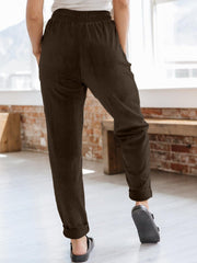 Corduroy drawstring tapered trousers in chocolate brown with cuffed hems.