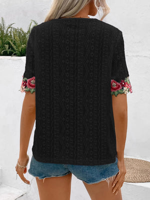 Black eyelet peasant blouse with embroidered floral sleeves and V-neck