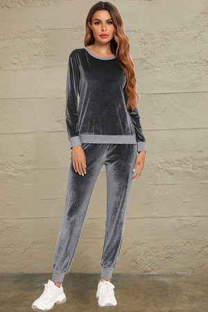 Velvet lounge set in charcoal with contrast trim crewneck top and jogger pants.