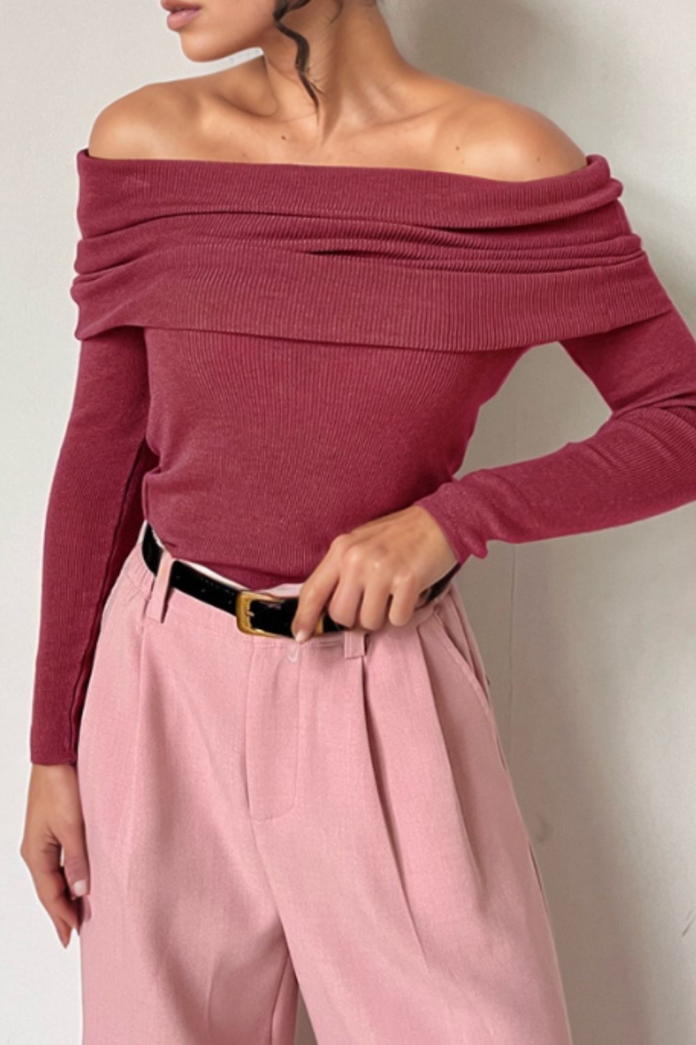 Deep Rose ribbed knit off-the-shoulder top with draped neckline and long sleeves.
