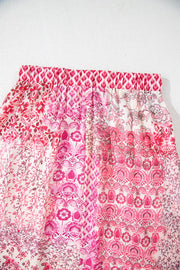 Printed tiered maxi skirt in dusty pink with a patchwork floral and geometric design.