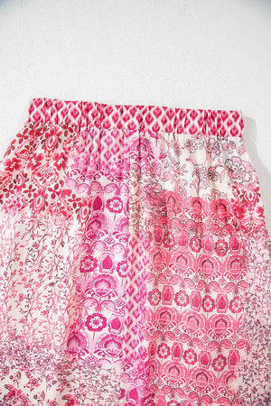 Printed tiered maxi skirt in dusty pink with a patchwork floral and geometric design.
