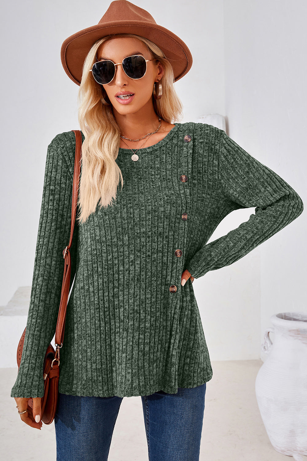 Matcha green ribbed knit top with asymmetric button detail and crew neck.