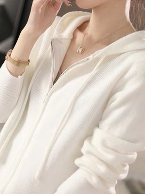 White ribbed knit zip-through hoodie with drawstring hood and silver zipper.