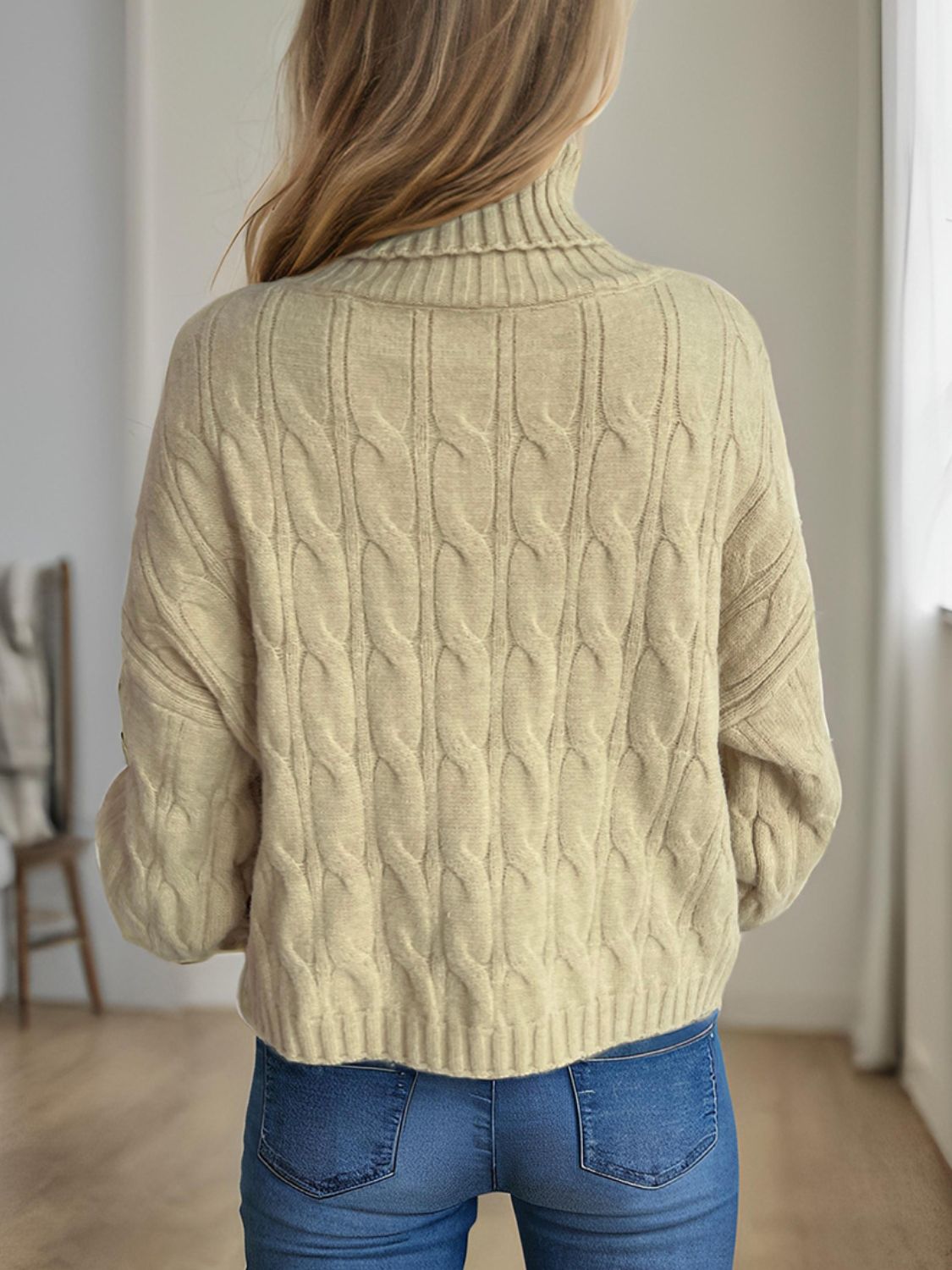 Oversized caramel cable knit turtleneck sweater with ribbed details.
